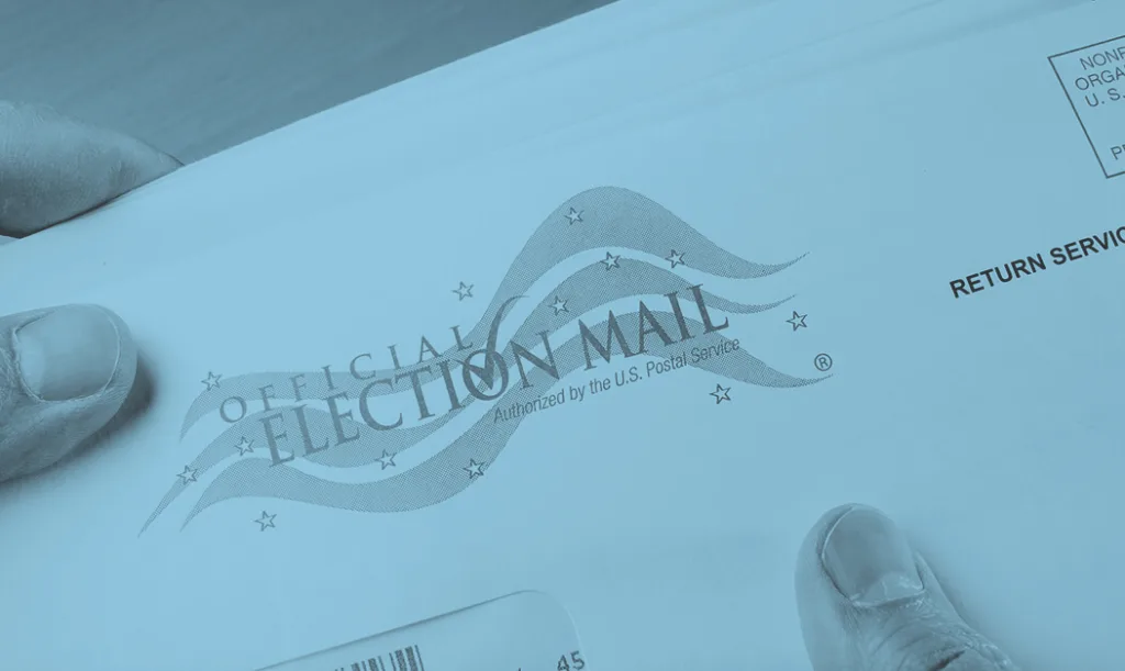 hand holding mail-in ballot