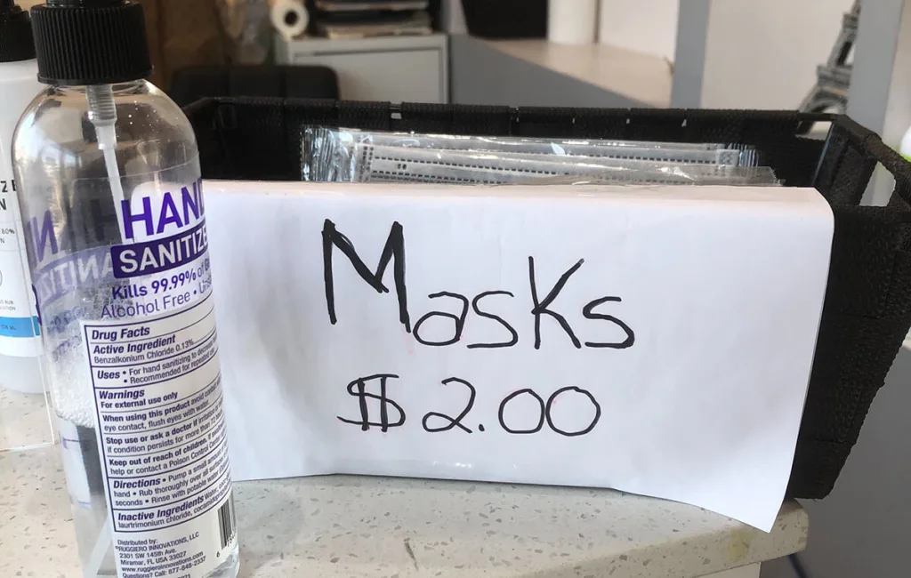 hand sanitizer and sign selling masks for $2