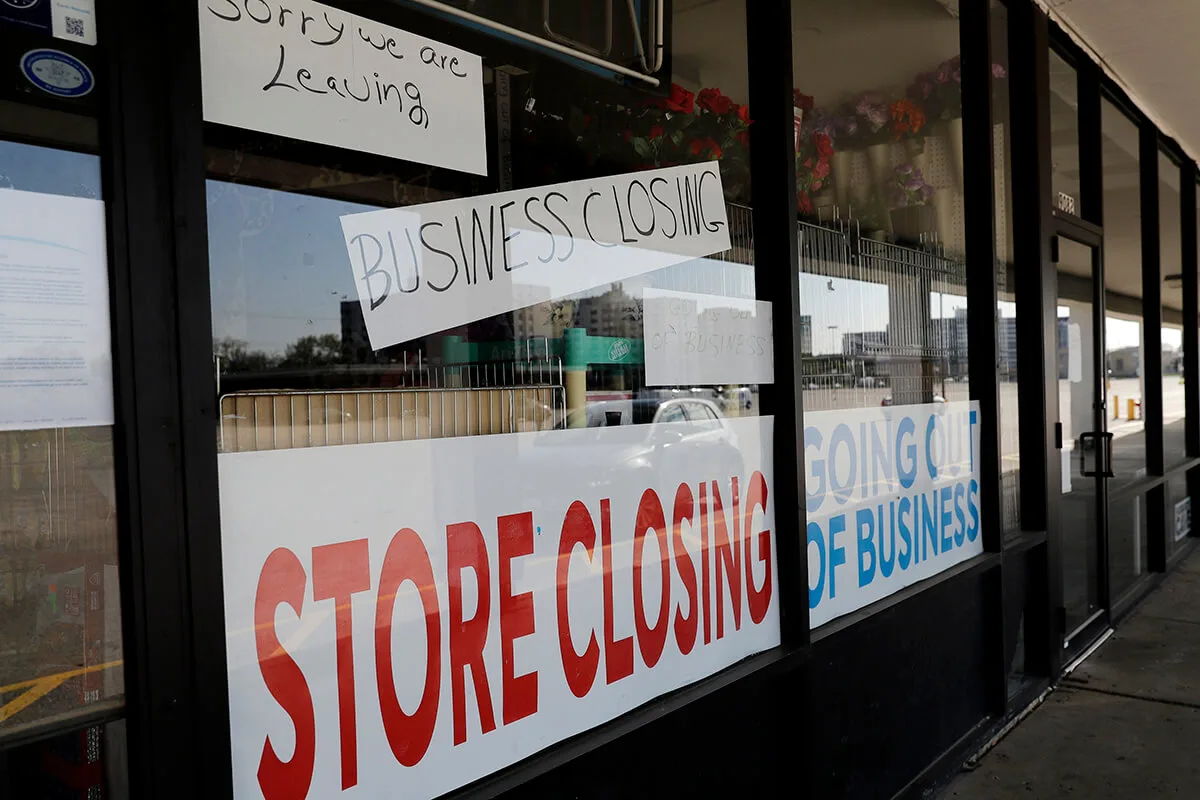 storefront with "store closing" signs