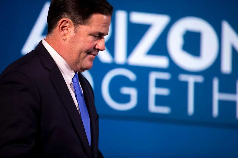 Gov. Ducey standing in front of "Arizona Together" sign