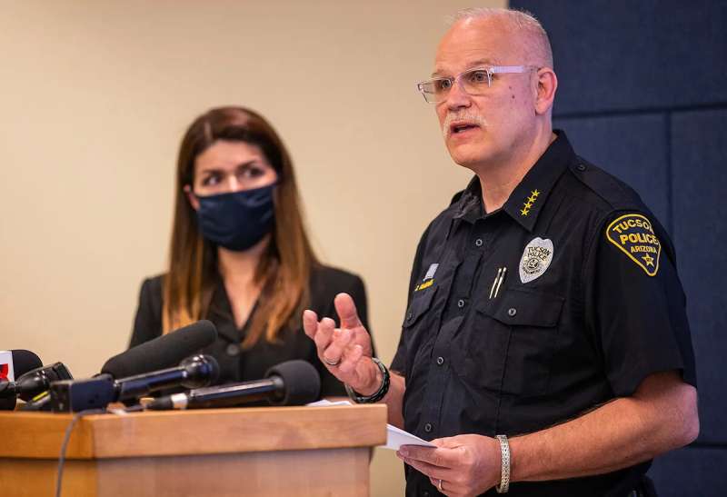Tucson mayor standing next to police chief as he speaks at podium