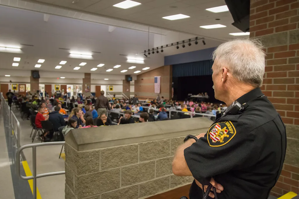 school resource officer looking students in cafeteria