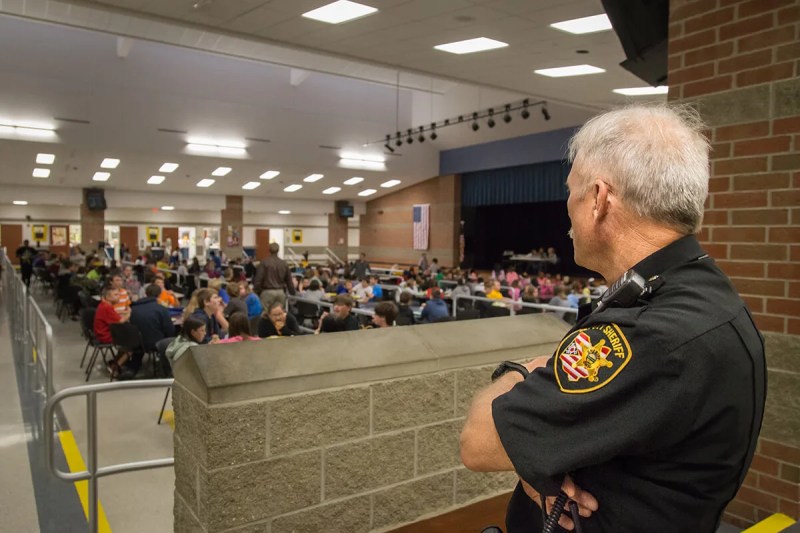 school resource officer looking students in cafeteria