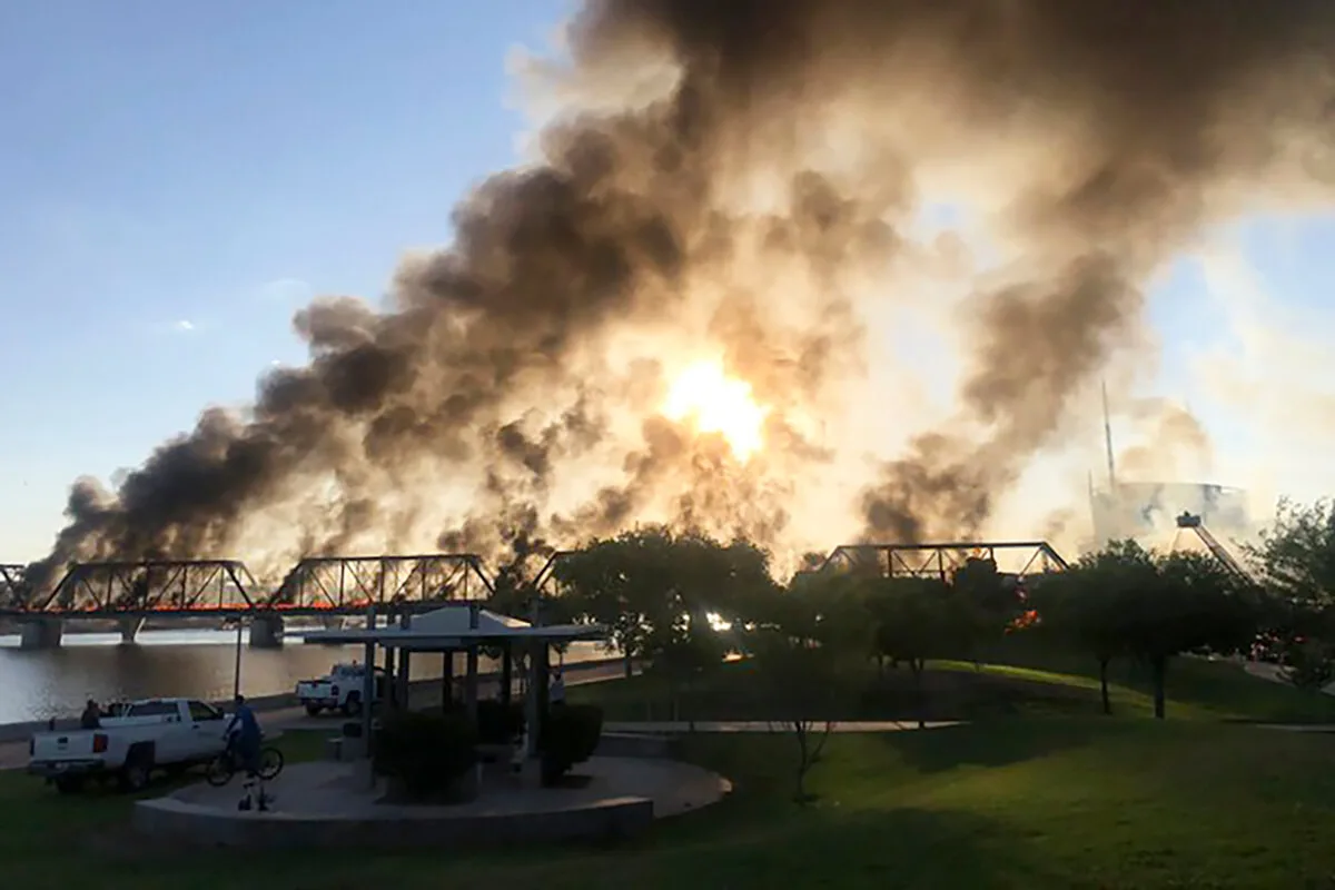 smoke billowing into air above Tempe railroad cars that caught fire