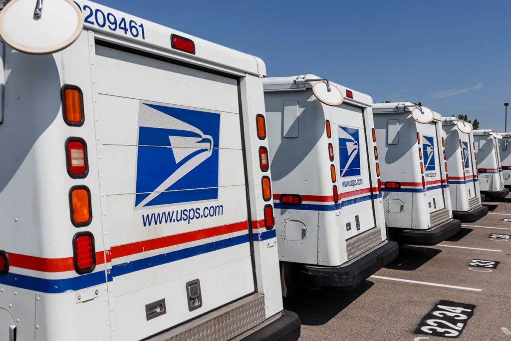 line of USPS mail trucks