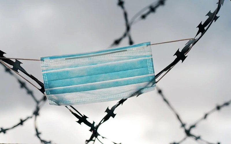 face mask caught in barbed wire