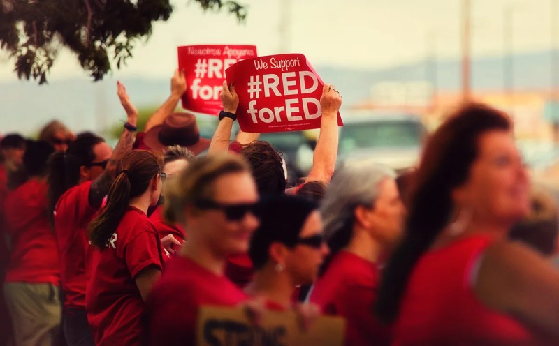 women holding Red for Ed signs at protest