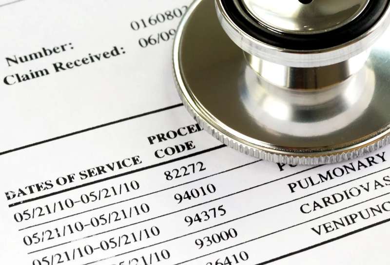 medical bill with stethoscope laid on top