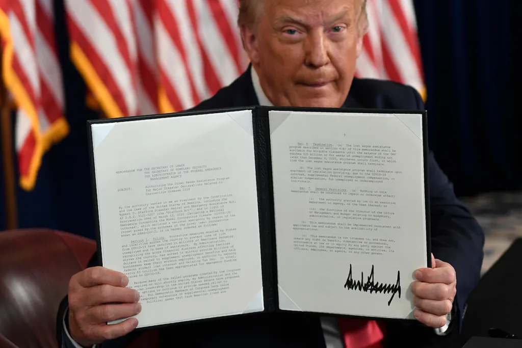 President Trump holding up his executive order