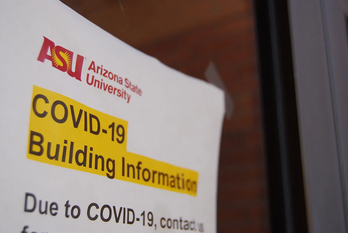 sign on door saying ASU COVID-19 building information