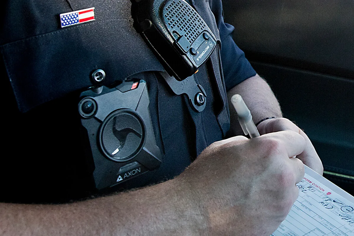police officer wearing a body cam writes a citation