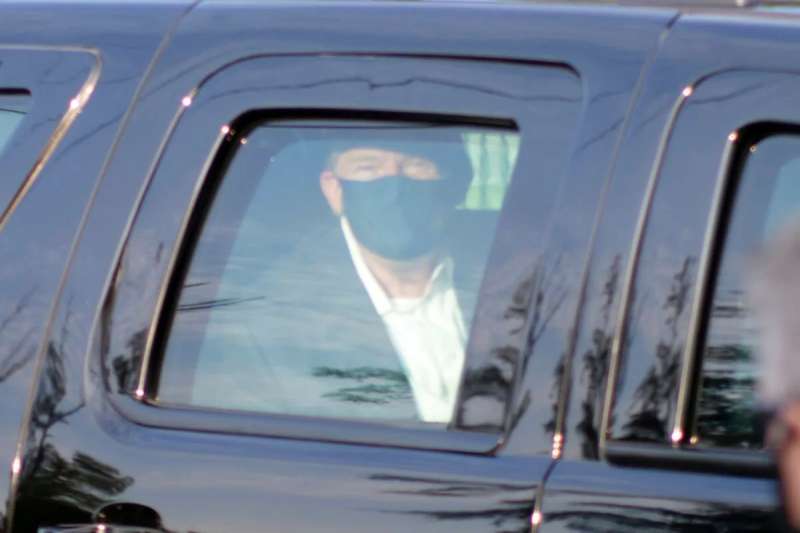 Contrary to the CDC's recommendations, President Trump left Walter Reed Medical Center over the weekend in a car full of Secret Service officers to wave to his supporters (AP Photo/Anthony Peltier).