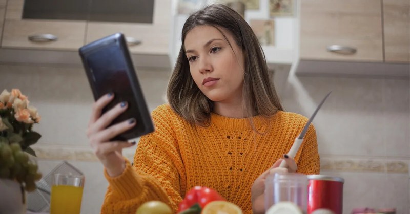 A red-haired, middle aged woman gazes off in the distance while her brunette companion urgently shares divergent political views.