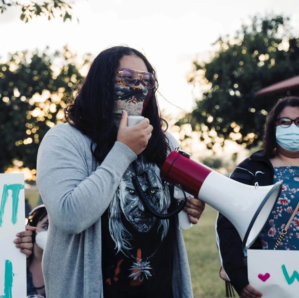 Maria Dominguez speaking into megaphone