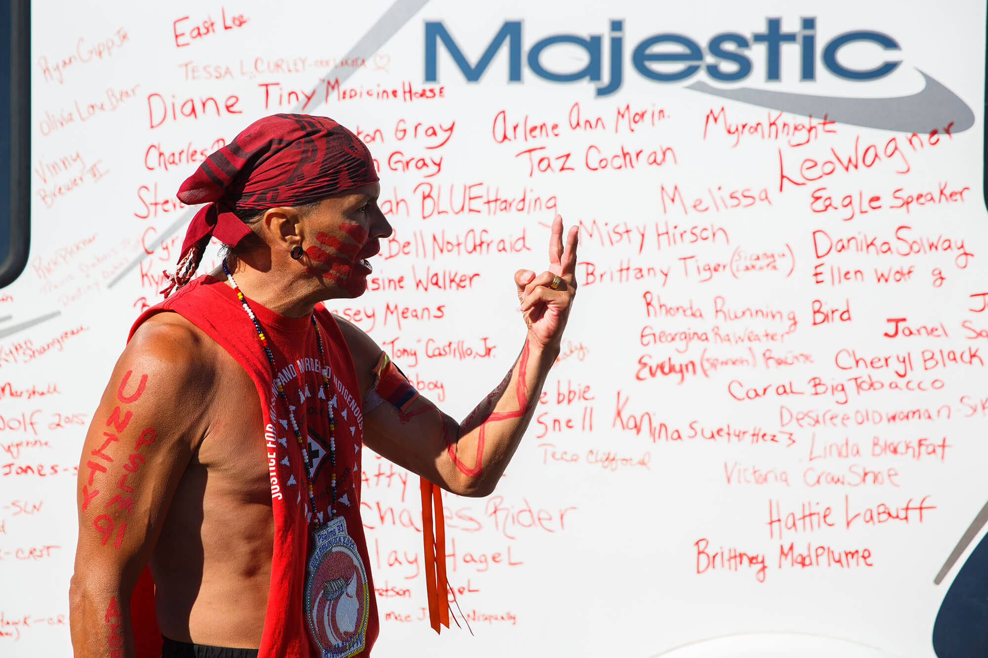 man standing in front of RV covered in names of missing Indigenous women