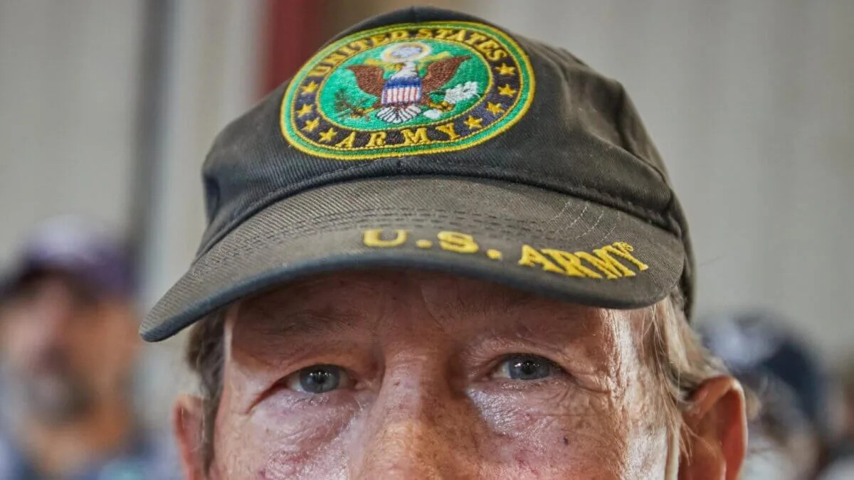 close-up of older man's face and US Army hat