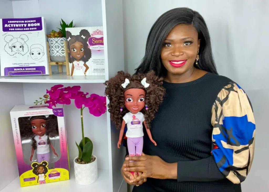 bukola somide holding somi doll a e x