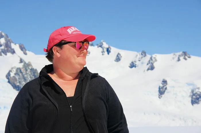 Dr. Joellen Russell in front of a glacier and blue sky