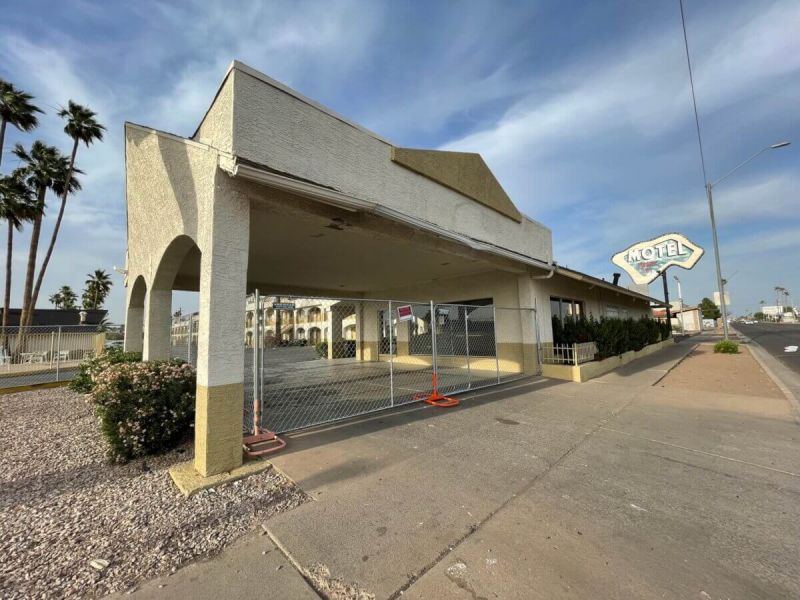 old closed down building with motel sign above it