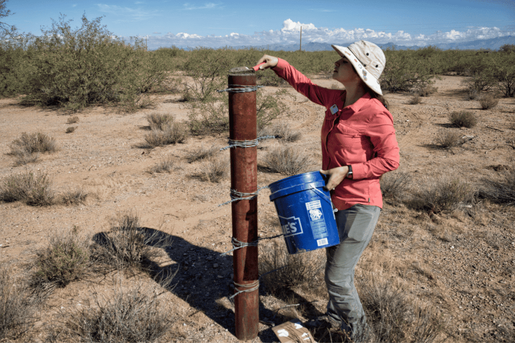 Desert Fence Busters member capping a pipe