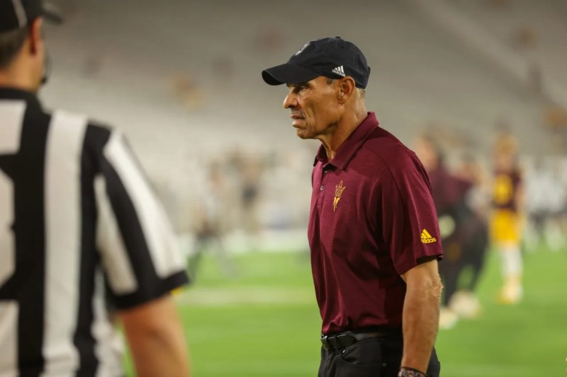Herm Edwards stating on football field