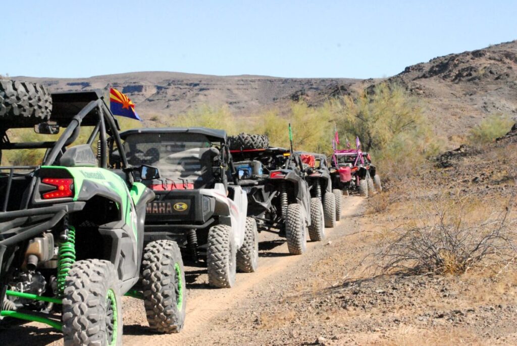 A line of ATVs in the desert.