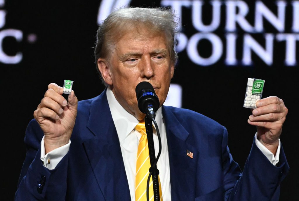 Former US President and 2024 Republican presidential candidate Donald Trump holds a big and a small box of tic-tac to illustrate inflation outcome during a town hall event at Dream City Church in Phoenix, Arizona, on June 6, 2024. (Photo by Jim WATSON / AFP) (Photo by JIM WATSON/AFP via Getty Images)