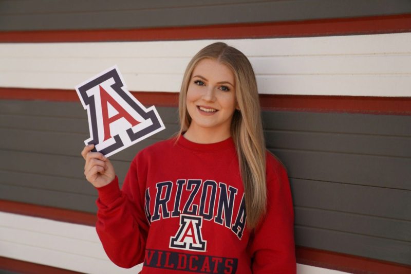 Young blonde girl wearing a University of Arizona sweatshirt.