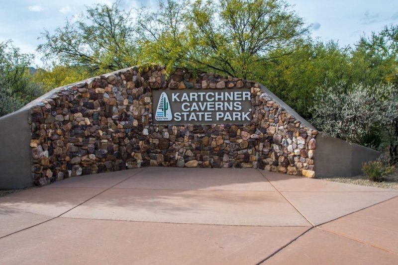 A welcoming signboard at the entry point of the preserve park saying Kartchner Caverns State Park.