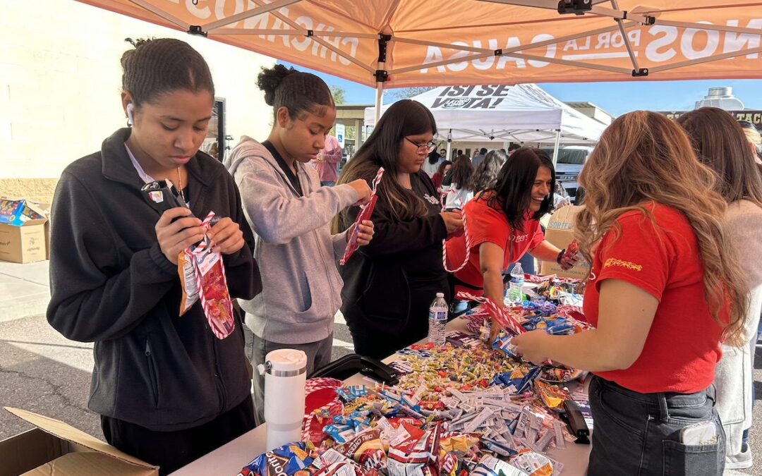 Nearly 100 volunteers stuff stockings in Phoenix for Chicanos Por La Causa’s holiday events