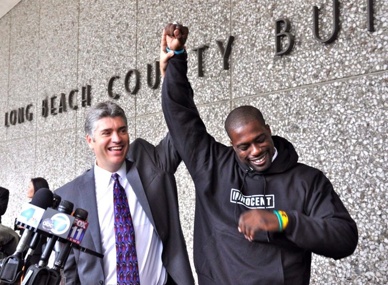 Two men celebrating outside of an Arizona court room.