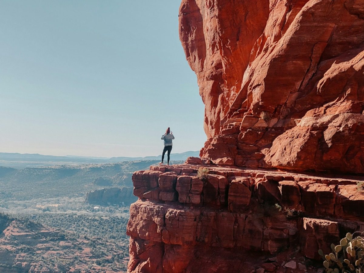 Woman standing on a rock face in an Arizona state park.