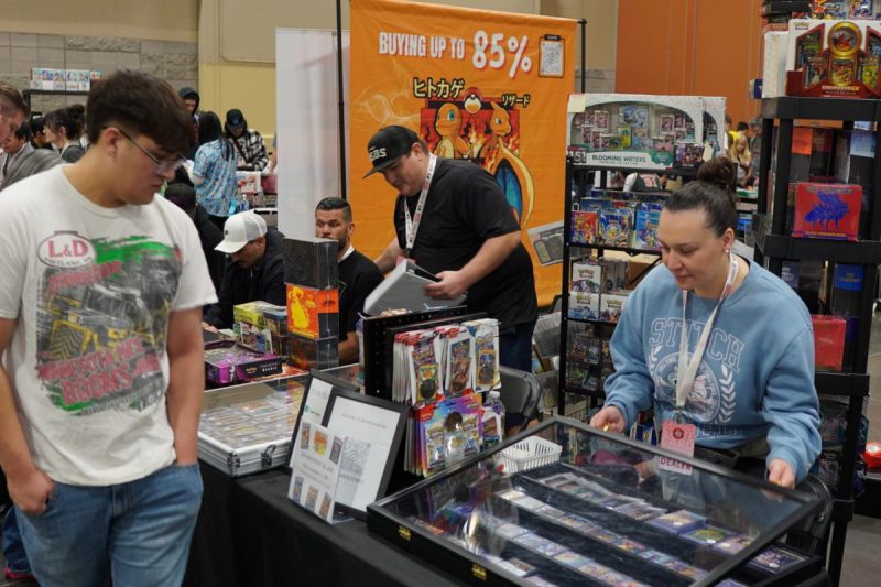people selling Pokemon cards at a booth