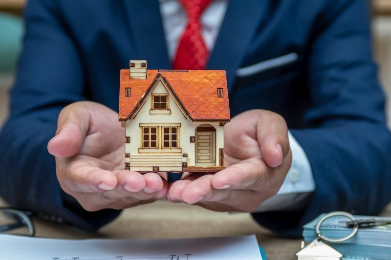 Business man hand and house model