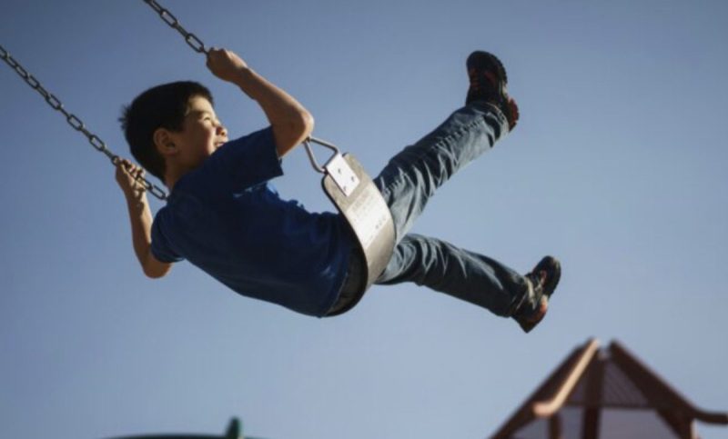 kid enjoying tucson playgound in summer
