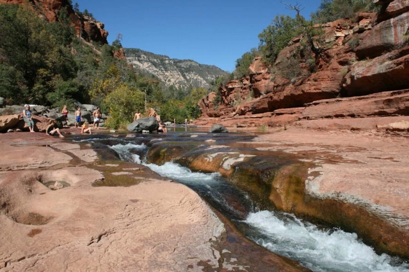 Hikers pass a creek in Arizona