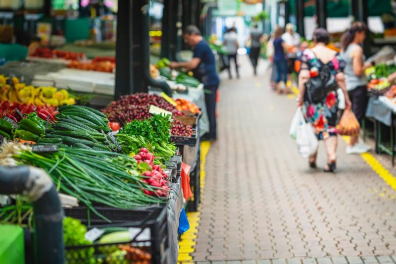 Fruits and veggies on display at an outdoor farmers market.