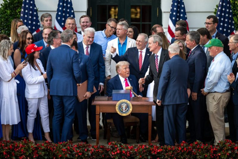 President Donald Trump speaks with Cabinet members and others