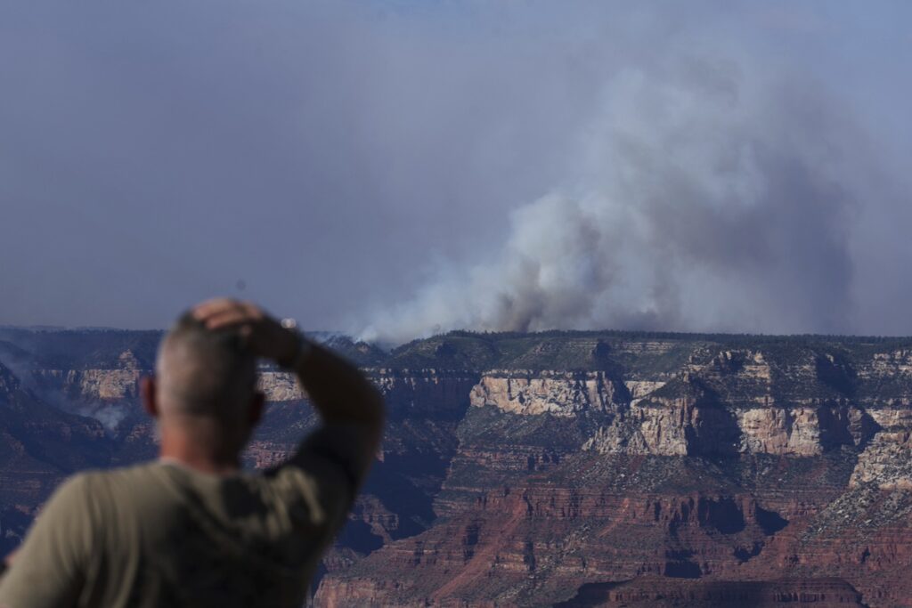 Smoke rises from the Dragon Bravo Fire at the Grand Canyon as seen from Mather Point near Grand Canyon Village