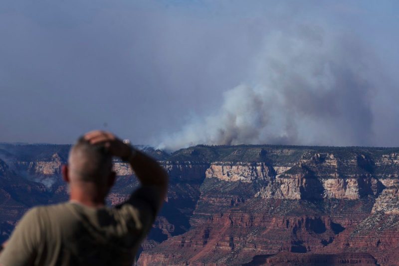 Smoke rises from the Dragon Bravo Fire at the Grand Canyon as seen from Mather Point near Grand Canyon Village