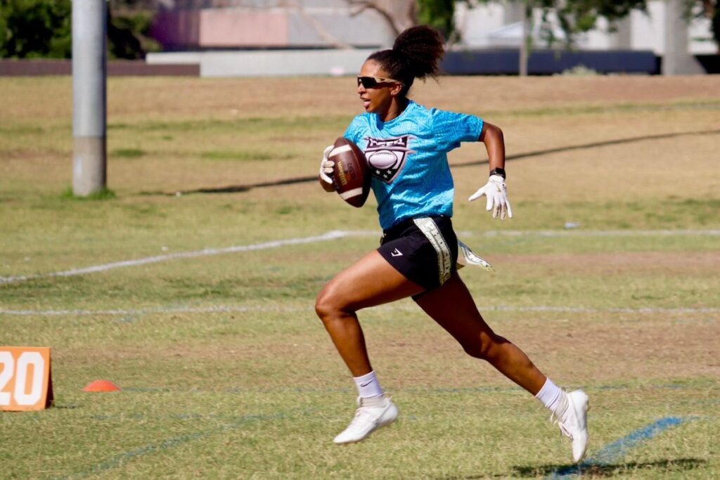 woman running with a football