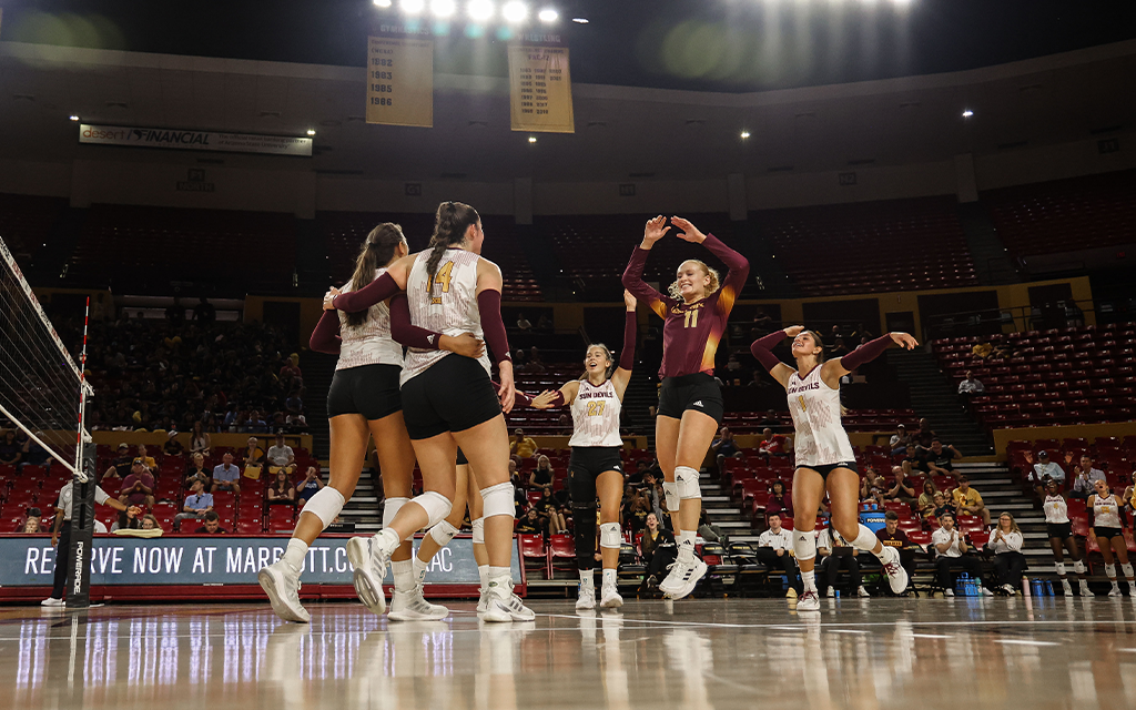 volleyball players celebrating on the court