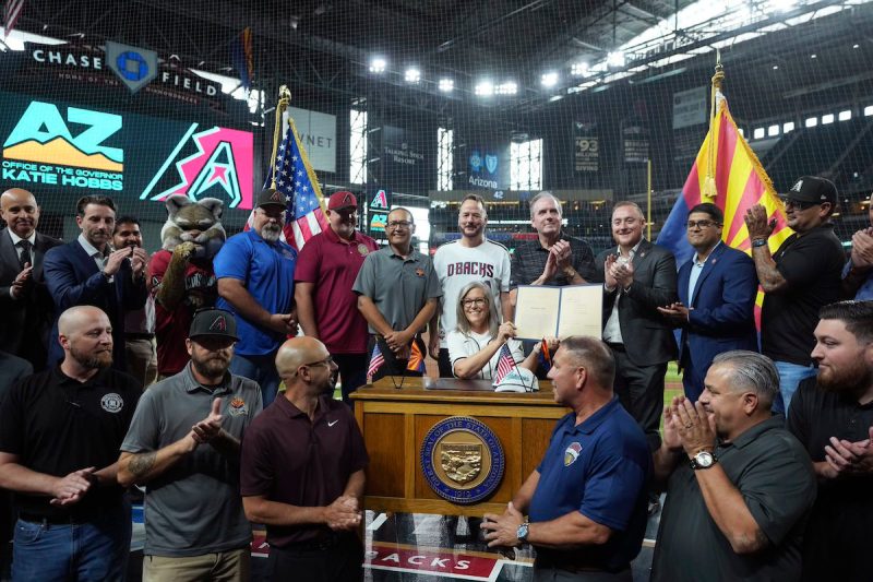 Arizona Democratic Gov. Katie Hobbs is joined by Arizona Diamondbacks staff on Chase Field