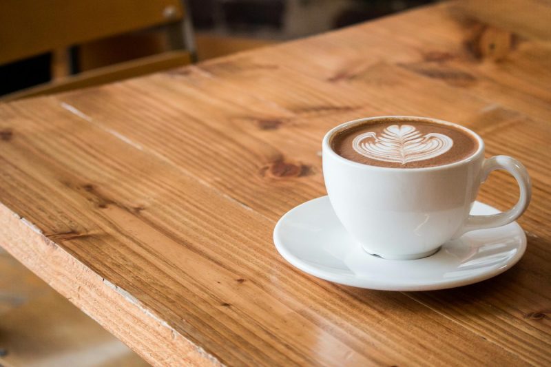 cup of coffee with latte art on a wooden table