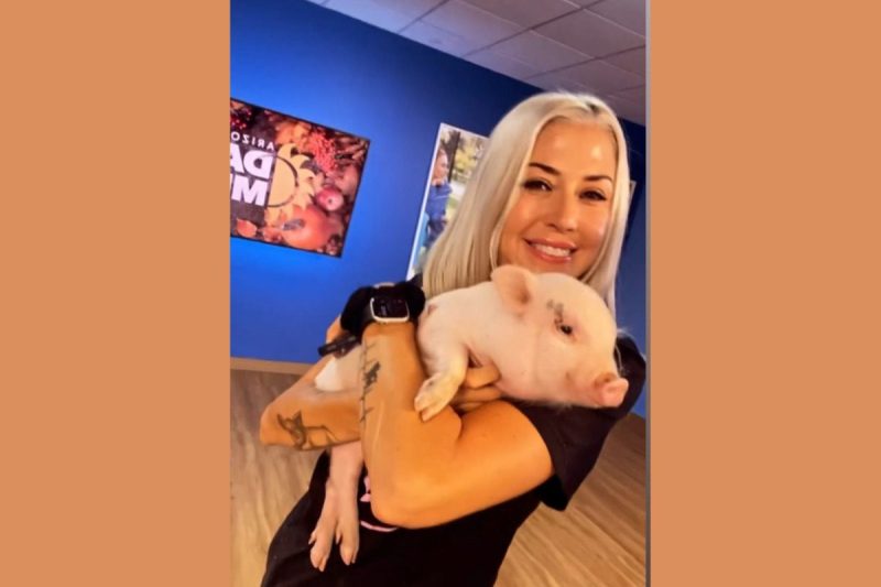 woman holding a pig