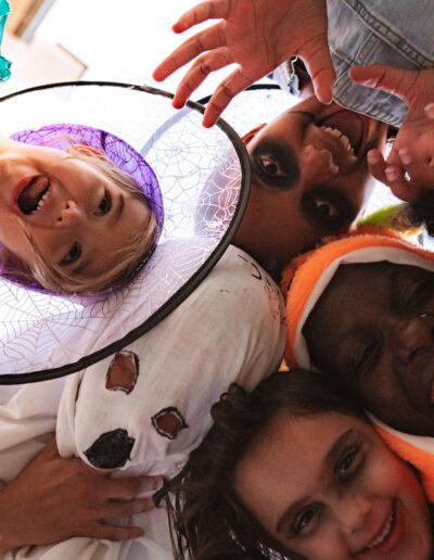 Children wearing Halloween costumes making funny faces