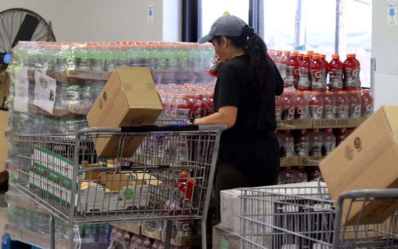 woman putting items in a shopping cart