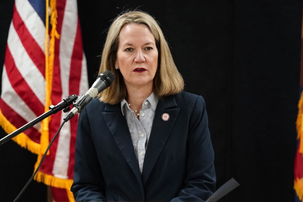 Arizona Attorney General Kris Mayes speaks into mic