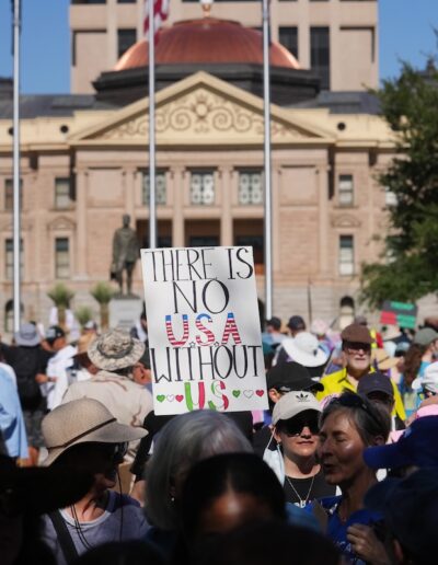 People protest Trump administration policies in front of the Arizona Capitol as part of a No Kings demonstration