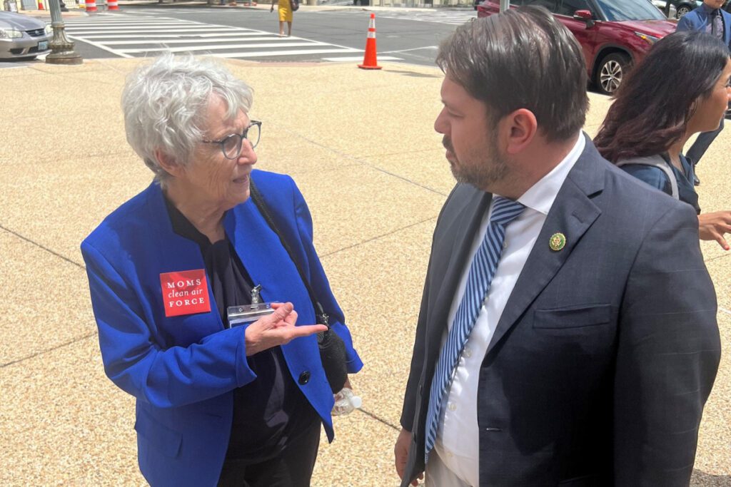 Hazel Chandler speaks with Ruben Gallego on a street